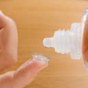 Contact lense being rinsed with solution