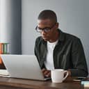 close-up of a businessman typing on a laptop in an office