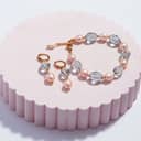 A fantasy stone bracelet and complementing earrings elegantly presented on a round stand.