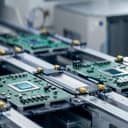 close-up of a circuit board equipped with a sophisticated microchip on the assembly line in an electronics manufacturing facility