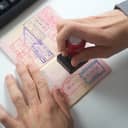 A person stamping a passport