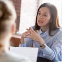 a woman discussing a harassment issue with an HR representative