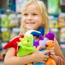 Happy girl holding a lot of plush toys