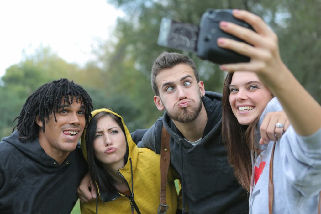 Four people making faces for a selfie