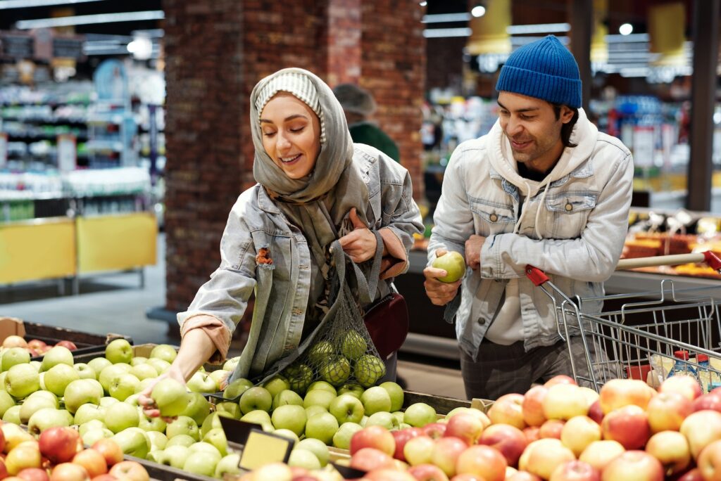 A couple shopping for apples in a supermarket